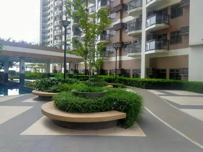 a courtyard of a building with trees and bushes at The Radiance Manila Bay in Manila