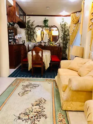 a living room with a table and a couch at THE MANSION- Near NAIA Airport Terminal PASAY in Manila