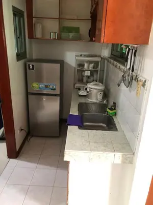 a small kitchen with a sink and a refrigerator at THE MANSION- Near NAIA Airport Terminal PASAY in Manila