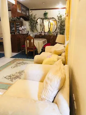 a room with four beds in a room with a table at THE MANSION- Near NAIA Airport Terminal PASAY in Manila