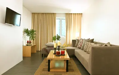 a living room with a couch and a table at Privato Ortigas in Manila