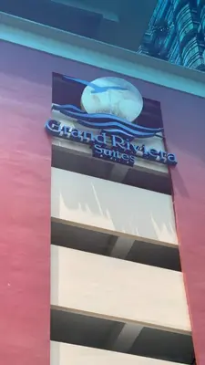 a sign on the side of a building at Grand Riviera Suites Comfy Condo near US Embassy Manila Bay Roxas Blvd Ermita Manila in Manila