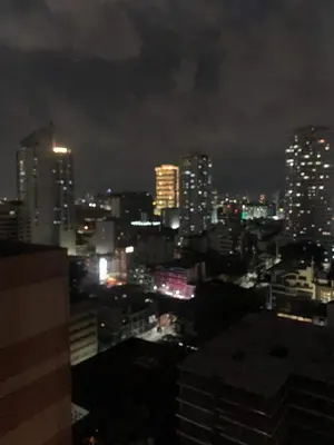 a view of a city at night at Grand Riviera Suites Comfy Condo near US Embassy Manila Bay Roxas Blvd Ermita Manila in Manila