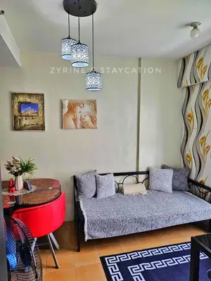 a living room with a couch and a table at The Rochester - Flat in Pasig near BGC in Manila