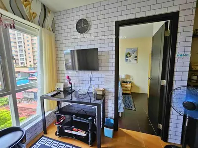 a room with a table and a tv on a wall at The Rochester - Flat in Pasig near BGC in Manila