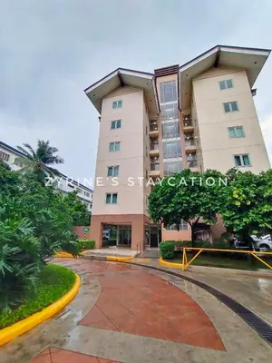a building in front of a parking lot at The Rochester - Flat in Pasig near BGC in Manila