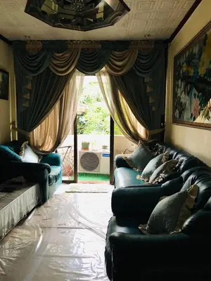 a living room with blue couches and a window at THE MANSION - 20 PAX LUXURY Near AIRPORT in PASAY in Manila