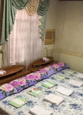a bedroom with a bed with flowers on it at THE MANSION - 20 PAX LUXURY Near AIRPORT in PASAY in Manila
