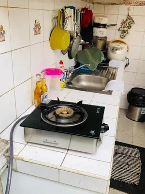 a stove top in a kitchen with a sink at THE MANSION - 20 PAX LUXURY Near AIRPORT in PASAY in Manila