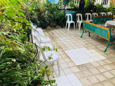a group of chairs and a bench on a patio at THE MANSION - 20 PAX LUXURY Near AIRPORT in PASAY in Manila