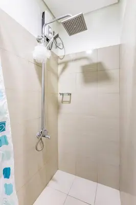 a bathroom with a shower with a shower curtain at Cozy 619 shore2 residence tower2 near MOA in Manila
