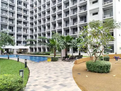a large building with a swimming pool in front of it at Cozy 619 shore2 residence tower2 near MOA in Manila