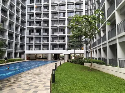 an external view of a building with a swimming pool at Cozy 619 shore2 residence tower2 near MOA in Manila
