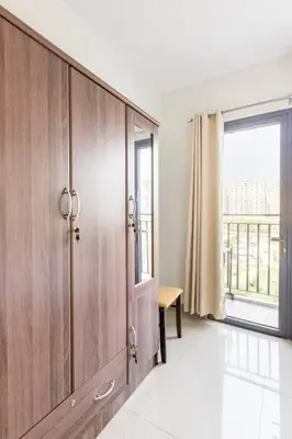 a large wooden cabinet in a room with a window at Cozy 619 shore2 residence tower2 near MOA in Manila