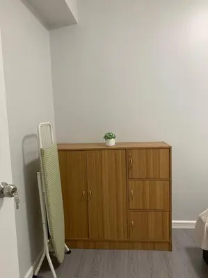 a wooden cabinet with a potted plant on top of it at Cozy 1 Bedroom near Alabang Town Center and Molito with Wifi and Netflix in Manila
