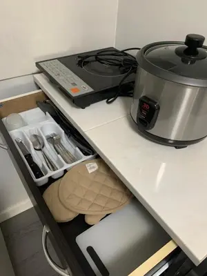 a slow cooker sitting on top of a kitchen counter at Cozy 1 Bedroom near Alabang Town Center and Molito with Wifi and Netflix in Manila