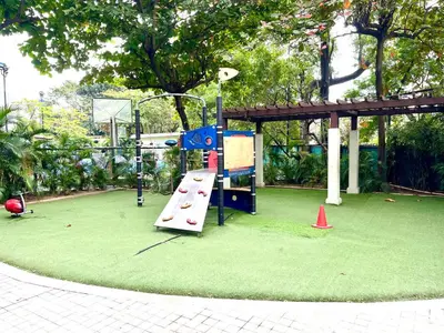 a playground with a slide in a park at The Rochester Parklane Condominium in Manila