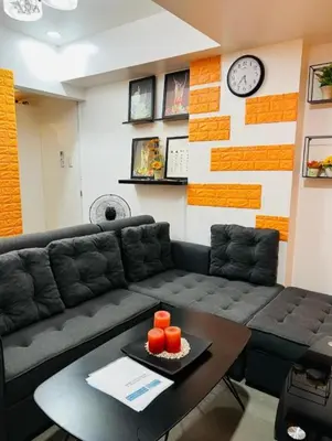 a living room with a couch and a table at AZURE URBAN RESORT Maldives tower in Manila