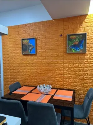 a dining room with a table and a wall at AZURE URBAN RESORT Maldives tower in Manila