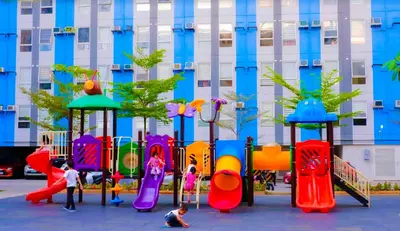 a playground in front of a building with children playing on it at Pandora's Nest in Manila