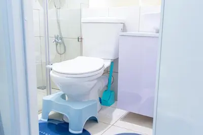 a bathroom with a white toilet and a shower at Pandora's Nest in Manila