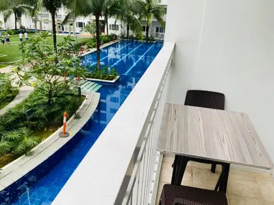 a view of a swimming pool from the balcony of a hotel at Shore Residence D2 - shortwalk Mall of Asia Near Airport in Manila