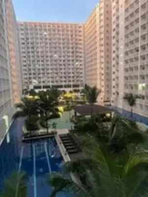 a view of a hotel with a pool and buildings at Shore Residence D5 Shortwalk Mall of Asia, Near Airport in Manila