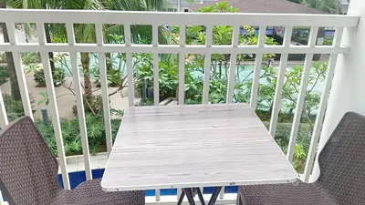 a table and two chairs on a balcony at Shore Residence D5 Shortwalk Mall of Asia, Near Airport in Manila