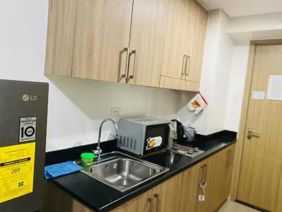 a kitchen with a sink and a microwave at Shore Residence D5 Shortwalk Mall of Asia, Near Airport in Manila