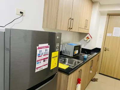 a kitchen with a refrigerator and a sink at Shore Residence D5 Shortwalk Mall of Asia, Near Airport in Manila