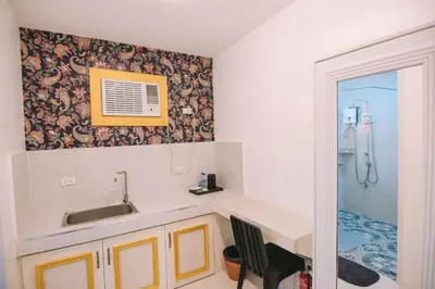 a bathroom with a sink and a shower at Villa Excellance Beach and Wave Pool Resort in Postema