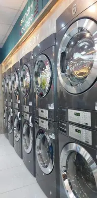 a row of washers and dryers in a store at Amesha Staycation in Manila