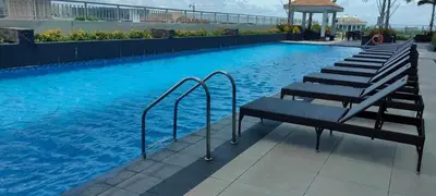 a swimming pool with a bench and stairs in it at Amesha Staycation in Manila
