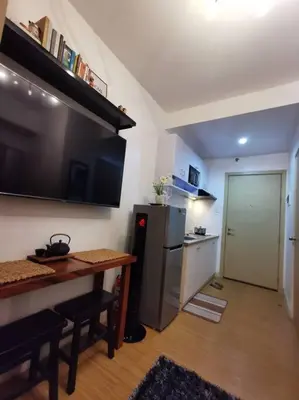 a small kitchen with a table and a refrigerator at Lot's Pad nr BGC in Manila