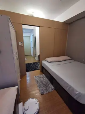 a small room with two beds and a bathroom at Lot's Pad nr BGC in Manila