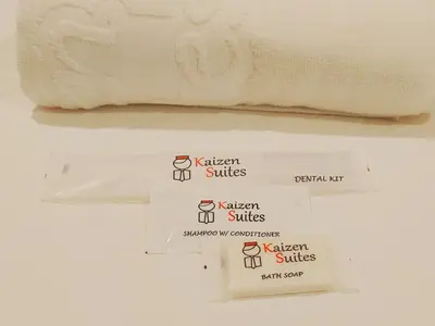 two different types of white towels on a shelf at Kaizen Suites in Manila