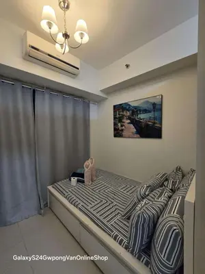 a bed with a teddy bear sitting on top of it at Sea Residences JEREMIAH2911-MALACHI310 in Manila