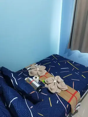a bed in a blue room with towels on it at Sea Residences JEREMIAH2911-MALACHI310 in Manila