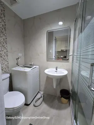 a bathroom with a toilet and a sink at Sea Residences JEREMIAH2911-MALACHI310 in Manila
