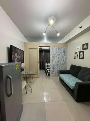 a living room with a couch and a table at Sea Residences JEREMIAH2911-MALACHI310 in Manila