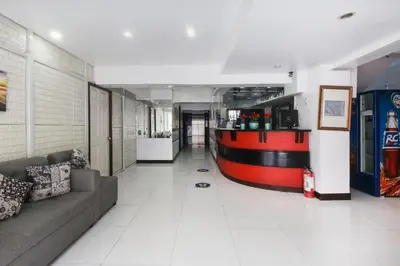 a living room with a couch and a bar at OYO 894 Cosmo Hotel P Campa Manila in Manila