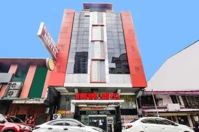 a building with cars parked in front of it at OYO 894 Cosmo Hotel P Campa Manila in Manila