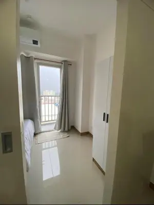 a room with a window and a bed in a room at 1BR unit in South Residence Las Pinas with Wifi & Netflix in Manila