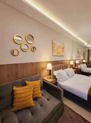 a hotel room with a bed and a couch at Fab Staycation @ MOA Complex - Fast Wifi + Netflix in Manila
