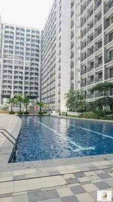 a swimming pool in a city with tall buildings at Fab Staycation @ MOA Complex - Fast Wifi + Netflix in Manila
