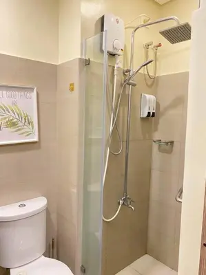 a bathroom with a shower with a toilet at Fab Staycation @ MOA Complex - Fast Wifi + Netflix in Manila