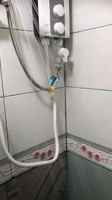 a hose is hooked up to a shower in a bathroom at THE MANSION - 24-HOUR Near AirPort Hostel 4 Backpackers in Manila