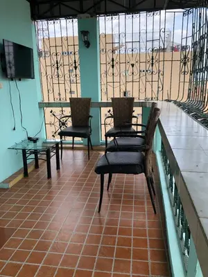 two chairs and a table in a room with windows at THE MANSION - BACKPACKERS Near AIRPORT in Manila