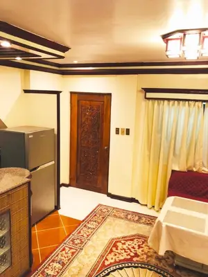 a living room with a refrigerator and a door at THE MANSION - BACKPACKERS Near AIRPORT in Manila