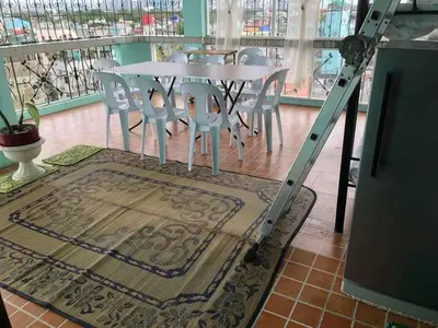 a white table and chairs with a ladder in a room at THE MANSION - BACKPACKERS Near AIRPORT in Manila